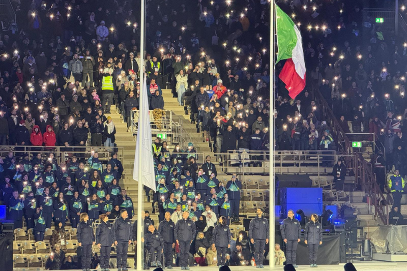 Una delegazione del Dipartimento issa la bandiera paralimpica alla cerimonia di apertura dei giochi invernali 2026